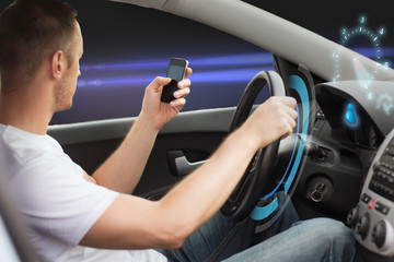 Naklejka premium man looking to smart phone while driving car