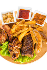 Roasted meat, sausages with corn and sauce
