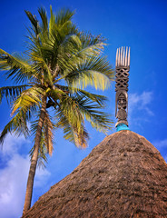 Wooden carved totem on a kanak hut, New caledonia