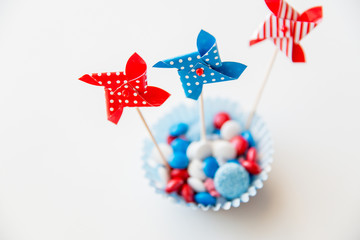 Obraz na płótnie Canvas candies with pinwheel toys on independence day