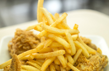 French fried with crispy fried chicken closeup