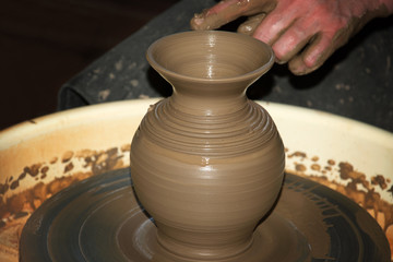 the clay pot is made hands of the person