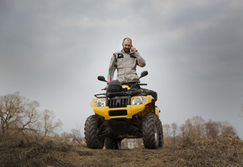 Fototapeta premium ATV driver talking on the phone while driving