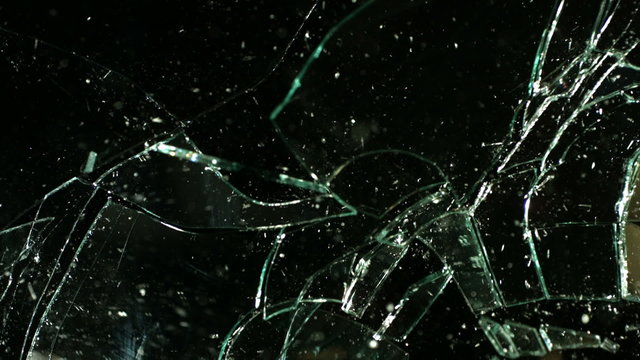 Glass shatters and falls, slow motion