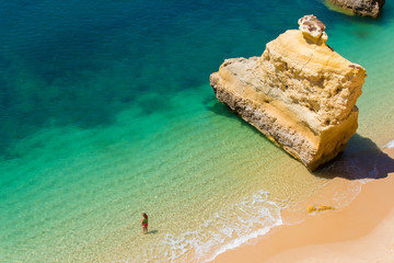 Girl relaxing at the Beautiful Beach in Algarve, Portugal - obrazy, fototapety, plakaty