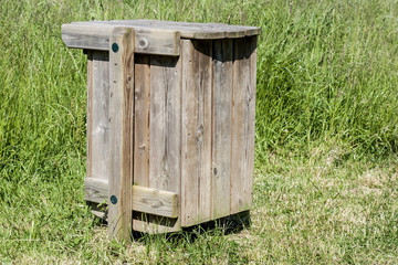 wooden garbage container in a park