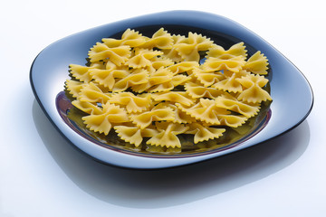 pasta in a black plate on white