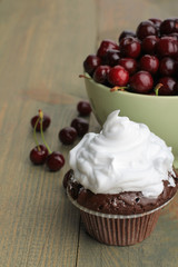 Chocolate Cupcakes with cherries on wooden background