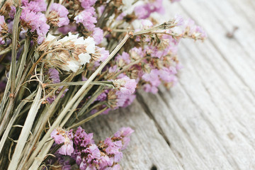 Closeup of dry flowers composition  wooden background.