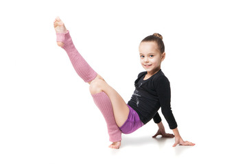 pretty little girl doing gymnastics over white background