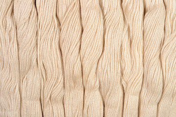 Beige skeins of floss as background texture