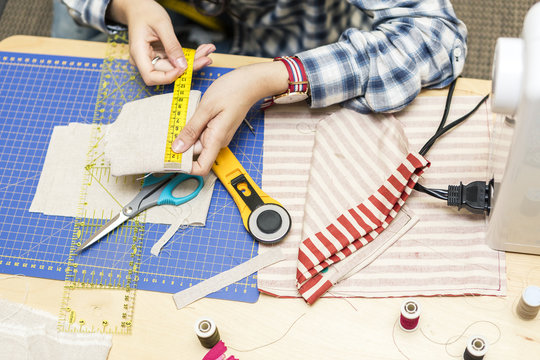 Young girl making hand bags and accessories at home