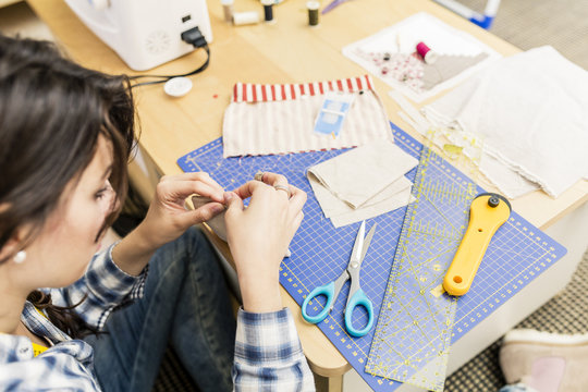Young girl making hand bags and accessories at home