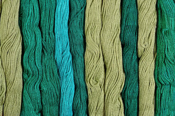 Green skeins of floss as background texture
