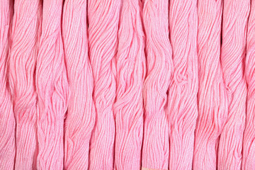 Pink skeins of floss as background texture