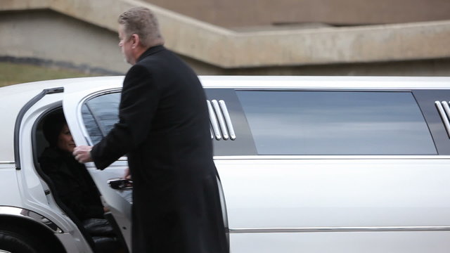 Businesswoman gets out of Limo