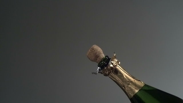 Cork pops off champagne bottle in super slow motion