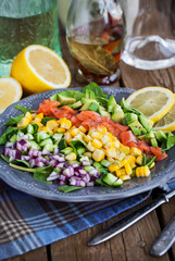 Salmon, avocado, corn, cucumber and onion salad