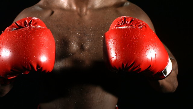 Boxer punching gloves together, slow motion