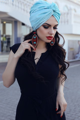 sensual woman  wearing elegant black dress and silk turban