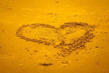Symbol of love on the sand beach.
