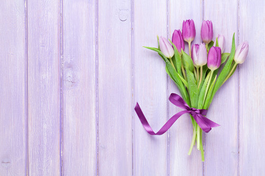 Fototapeta Purple tulips over wooden table