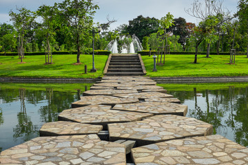 Beautiful stone bridge across the lake in the park