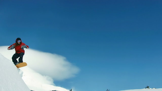 Snowboarder jumps into sky, slow motion