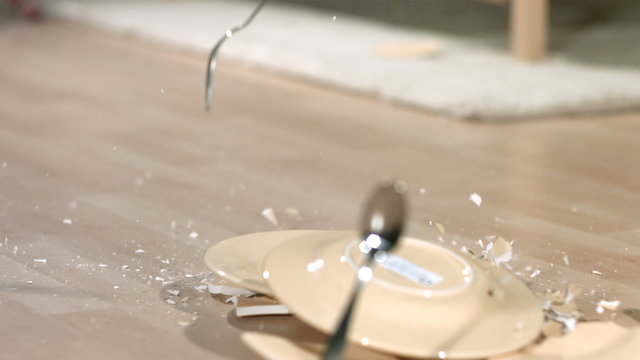 Dishes breaking backwards in slow motion