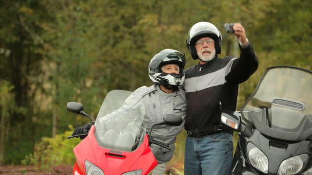 Senior couple on scooters, ready to ride