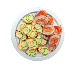 Sandwiches with pike caviar, pate and vegetables on a plate, white background