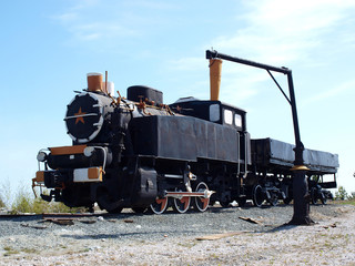 Fototapeta na wymiar Old soviet locomotive on a background of blue sky