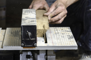 Naklejka premium A carpenter works on woodworking the machine tool.