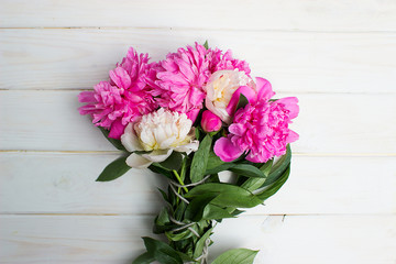 bouquet of beautiful flowers on a white wooden background. Pink and white peonies