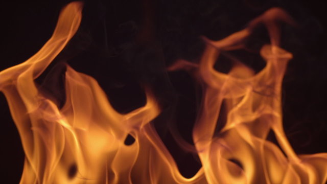 Closeup of fire burning on black background in slow motion