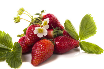 a bunch of ripe strawberries with leaves and flowers