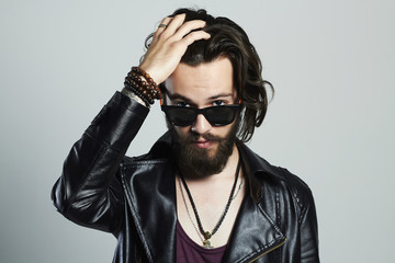 handsome bearded man in leather jacket.Hipster in sunglasses