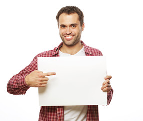 young bearded man showing blank signboard