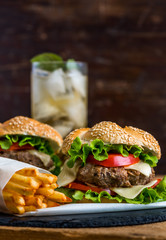 Homemade Hamburger with Fresh Vegetables and Drink with Ice