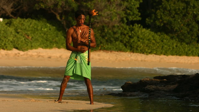 Hawaiian fire knife dancer performs