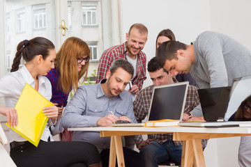 Young group of people discussing business plans.