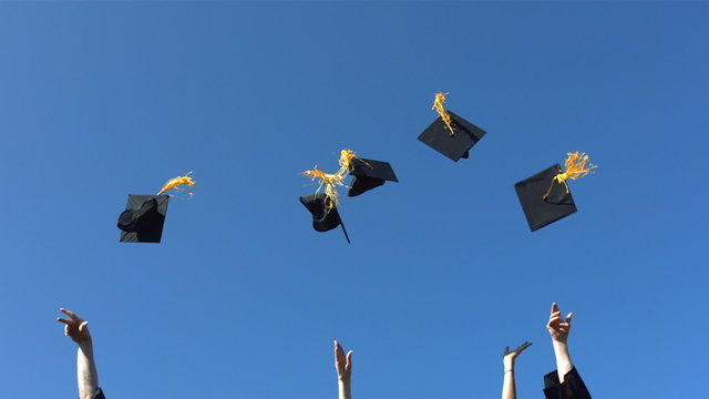 Tossing graduation caps, slow motion