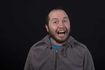 Obraz premium man laughing out loud isolated on black background
