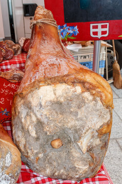 Whole cured ham for sale on a delicatessen stall