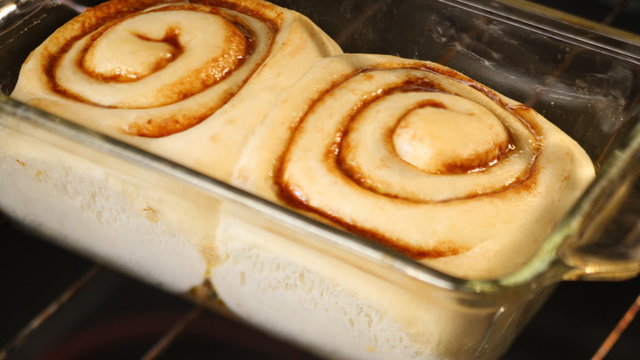 Time lapse shot of cinnamon rolls baking in oven