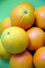 Navel orange fruits on green background