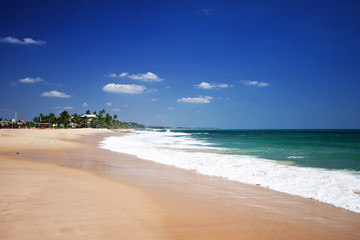 Untouched tropical beach with fishing boat in Sri Lanka