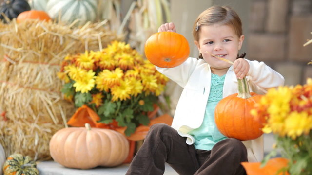 Portrait of young girl with pumpkins in the Fall