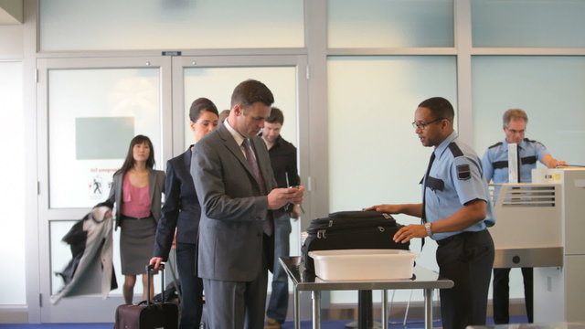 Group Of Business People At Airport Security Checkpoint