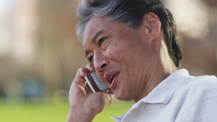 Senior Asian man talking on cell phone
